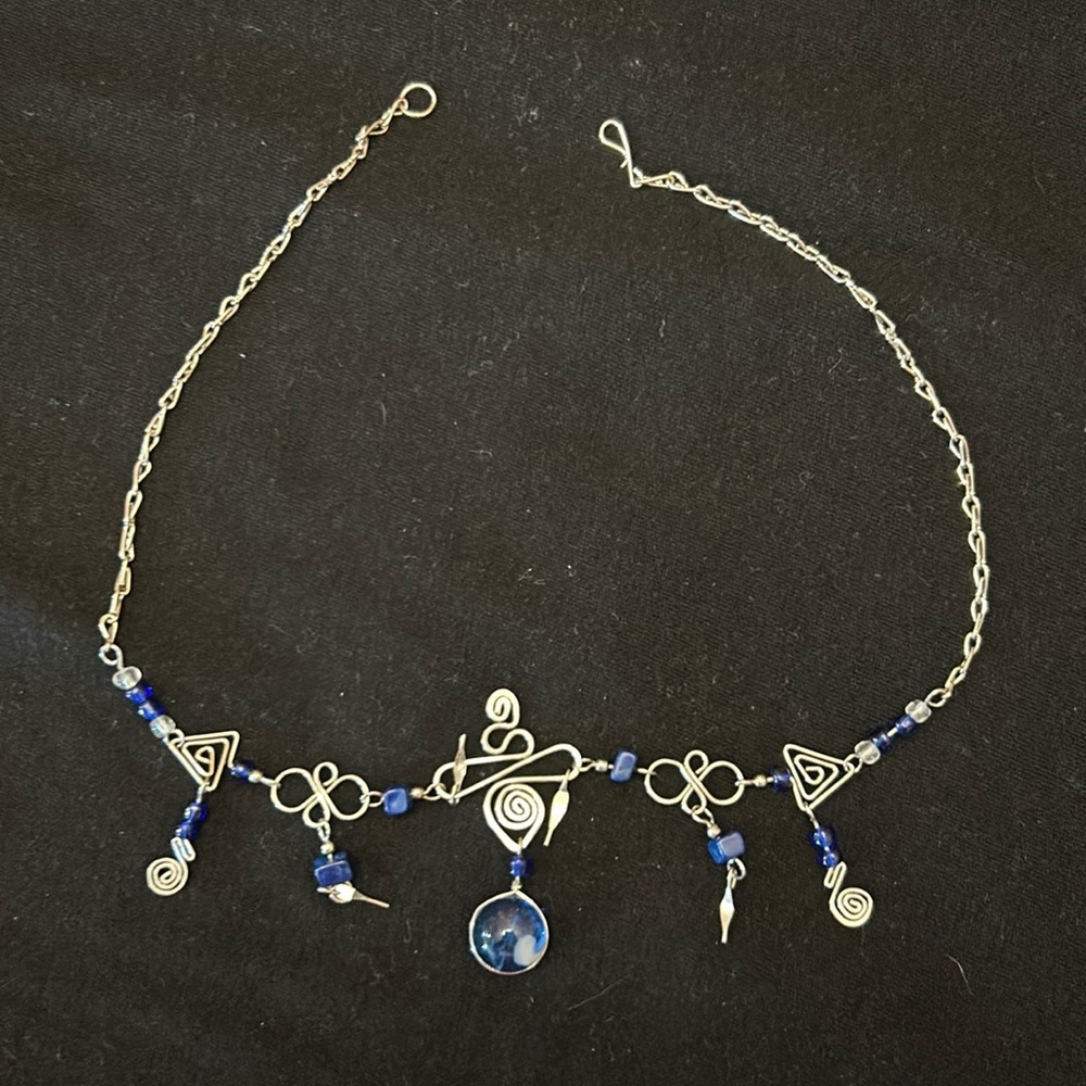 Silver plated necklace with blue stones.